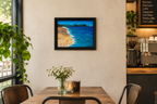 11x14" original mixed media acrylic painting, ocean, sand, shells, framed in black, shown in cafe