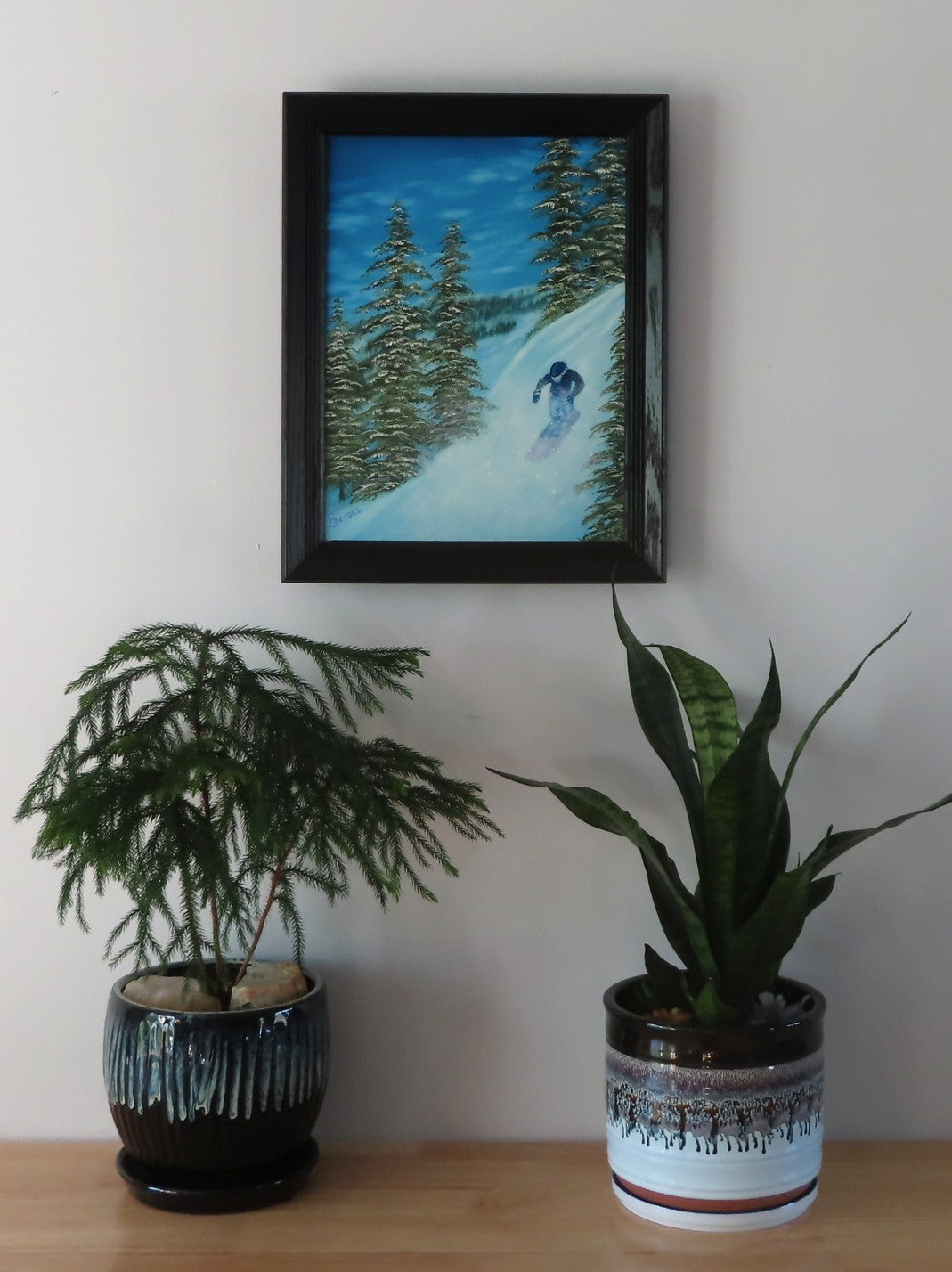 Original 12x16 oil painting, snowboarder on mountain, framed, shown on wall over a table