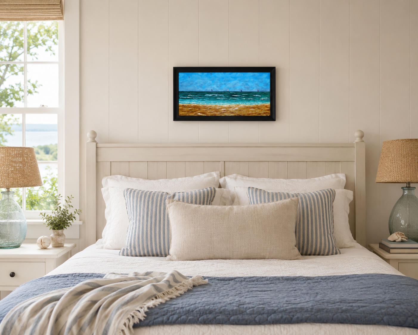 12x24 original oil painting of ocean, waves, sailboats, paragliders, and sandy beach, framed in black, displayed over bed