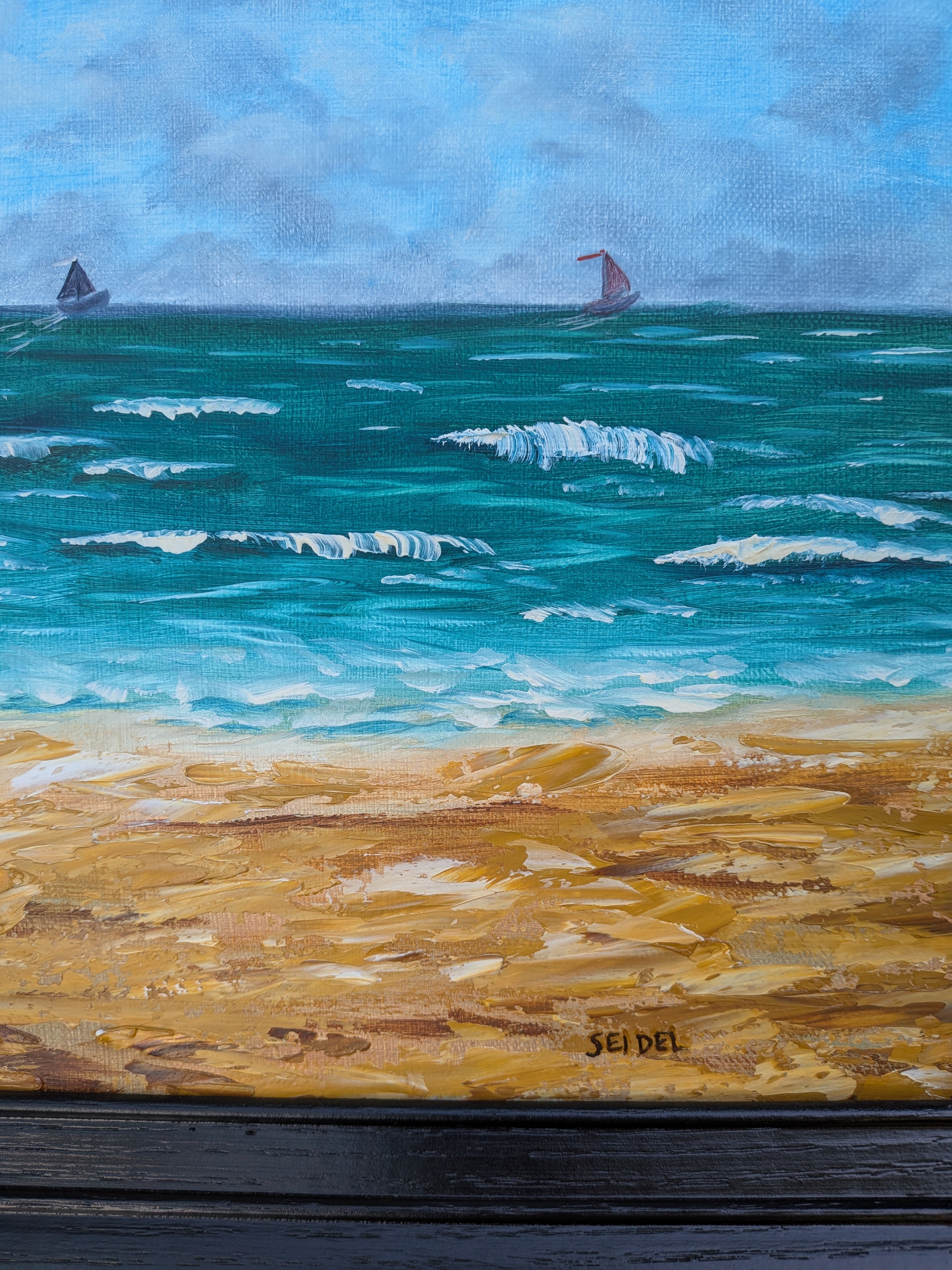12x24 original oil painting of ocean, waves, sailboats, paragliders, and sandy beach, framed in black, close-up of texture