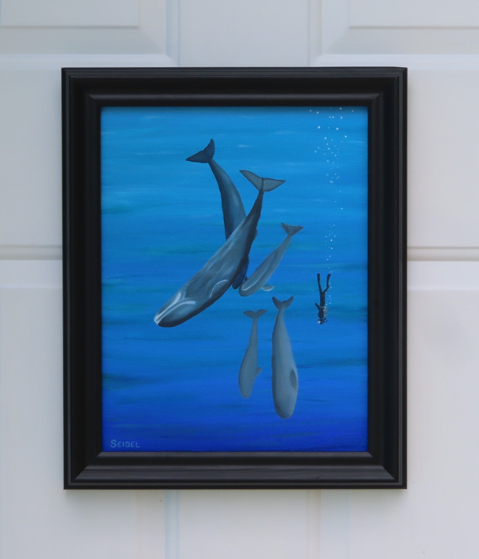 11x14 original oil painting of a scuba diver swimming with whales, framed in black