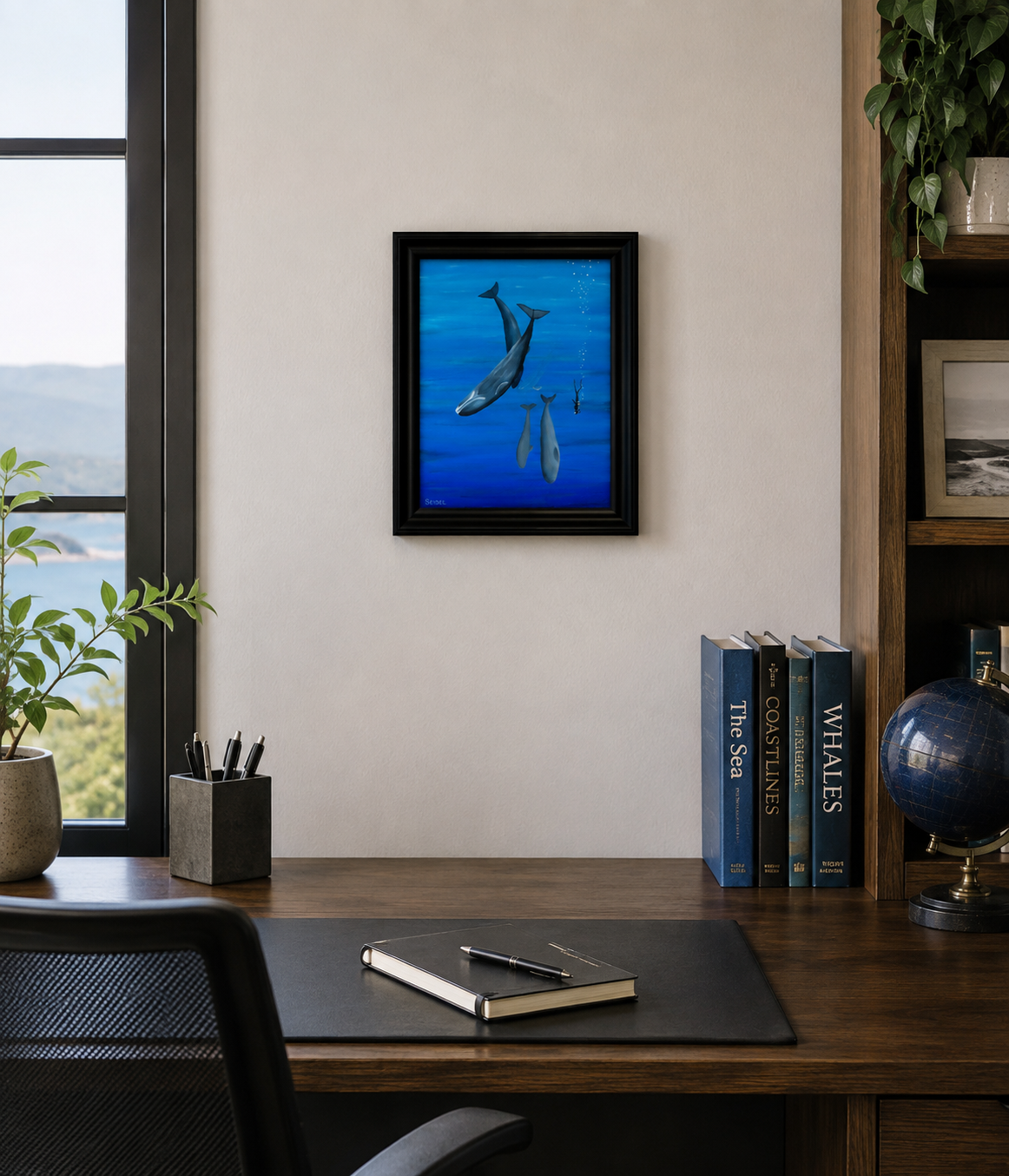 11x14 original oil painting of a scuba diver swimming with whales, framed shown in an office