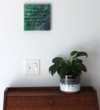 8x8" canvas with liquid art acrylic and inspirational quote. Colors are multiple greens with purple and gold accents, shown over a secretary desk