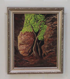 An original 16x20 oil painting on canvas featuring a lone tree with bright green leaves, illuminated by sunlight, with a dark, mysterious background and a rocky cavern, displayed in an ornate wood frame