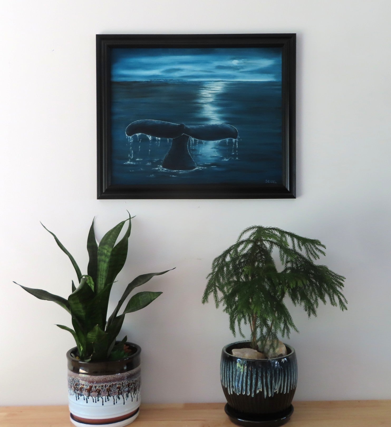 original 16x20 oil painting, moody skies, ocean, whale flukes, framed in black, displayed over table