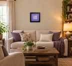 An 8x8" original framed artwork with a purple background and a black frame, featuring a textual message 'You are a work of art' alongside a key, displayed in a cozy livingroom.