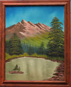 16 x 20 original oil painting, mountains, evergreens and lake with a small island in it. Light walnut frame